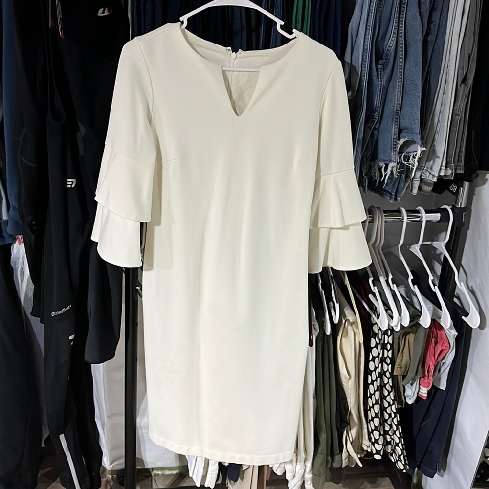 Beautiful cream dress with 3/4 ruffle sleeves.